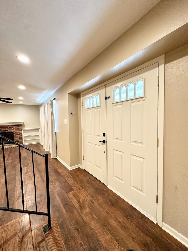 2804 Hollywood Dr, Arlington, TX 76013 - foyer with a brick fireplace, baseboards, and dark wood finished floors