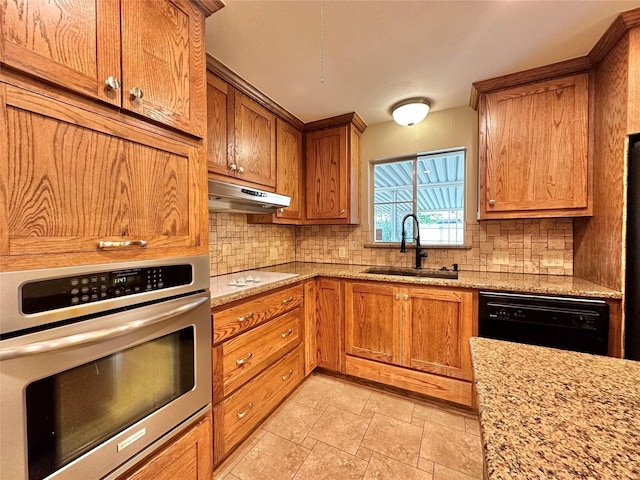 2804 Hollywood Dr, Arlington, TX 76013 - kitchen featuring a sink, under cabinet range hood, black dishwasher, tasteful backsplash, and stainless steel oven
