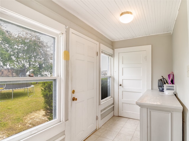 entryway with light tile patterned flooring and plenty of natural light