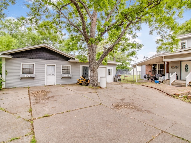 exterior space with an attached garage, fence, and concrete driveway