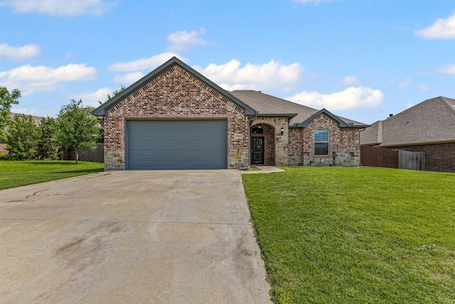view of front of home with brick siding, fence, a front yard, concrete driveway, and an attached garage