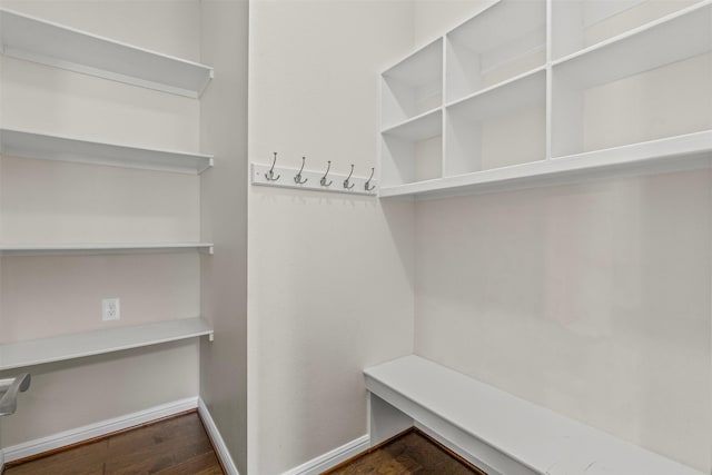 mudroom featuring baseboards and wood finished floors