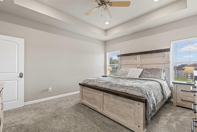 bedroom with recessed lighting, ceiling fan, carpet flooring, baseboards, and a raised ceiling