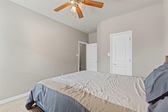carpeted bedroom featuring ceiling fan and baseboards