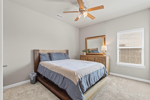 carpeted bedroom with visible vents, ceiling fan, and baseboards