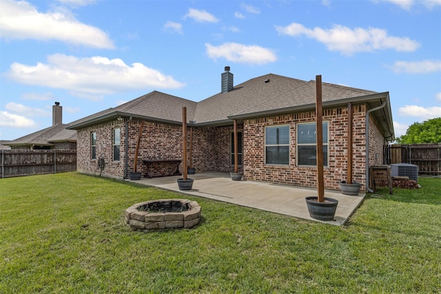 back of property with a patio, an outdoor fire pit, a fenced backyard, cooling unit, and brick siding