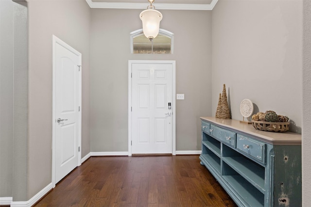 entrance foyer featuring ornamental molding, baseboards, and dark wood finished floors