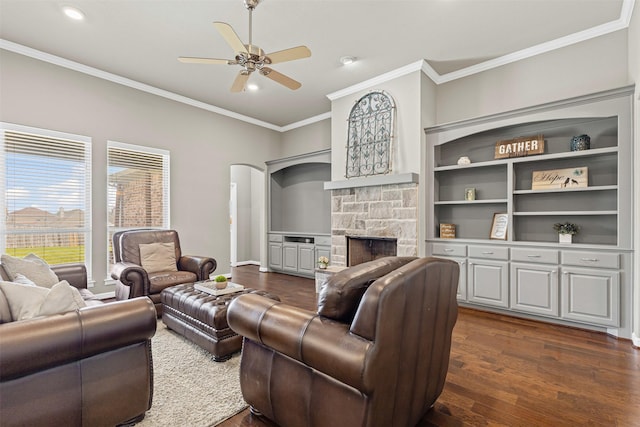 living area featuring recessed lighting, ornamental molding, ceiling fan, a fireplace, and dark wood-style floors