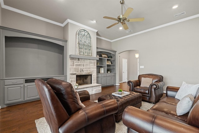 living room with dark wood finished floors, arched walkways, ceiling fan, visible vents, and crown molding