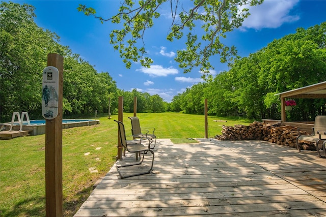 wooden deck with a yard and an outdoor pool