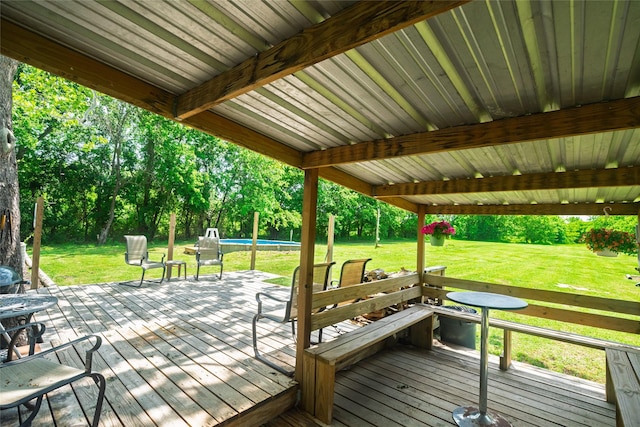 wooden terrace with a yard and an outdoor pool