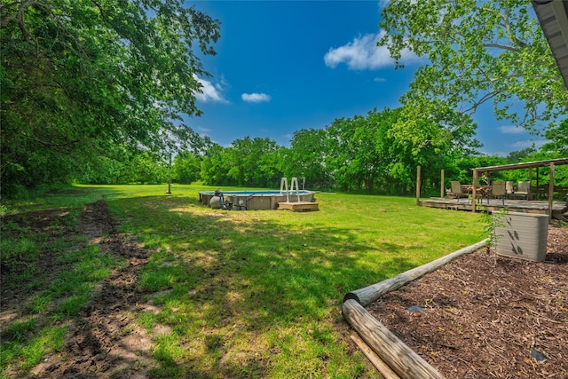 view of yard with a deck and an outdoor pool