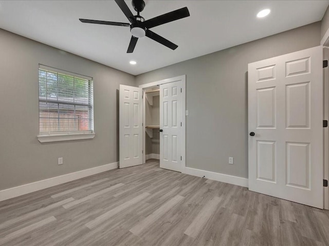 unfurnished bedroom with recessed lighting, a closet, ceiling fan, baseboards, and wood finished floors