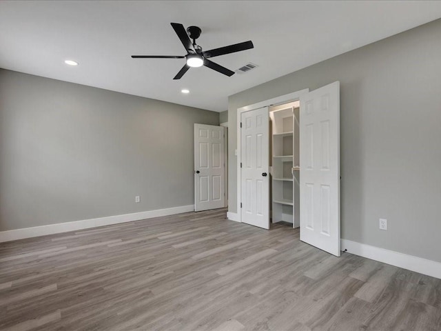 unfurnished bedroom featuring recessed lighting, visible vents, wood finished floors, and baseboards