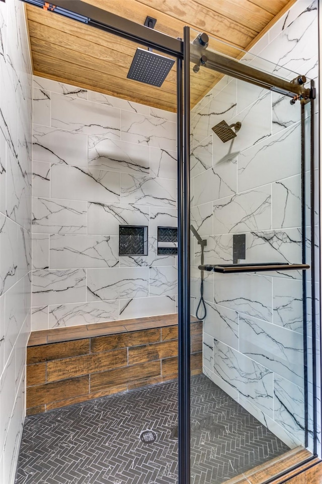 full bath with a stall shower and brick patterned floors