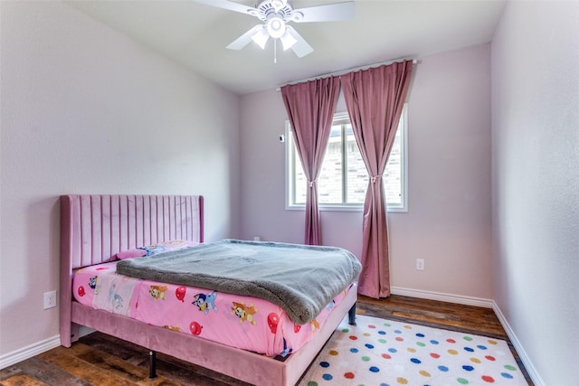 bedroom featuring wood finished floors, baseboards, and ceiling fan