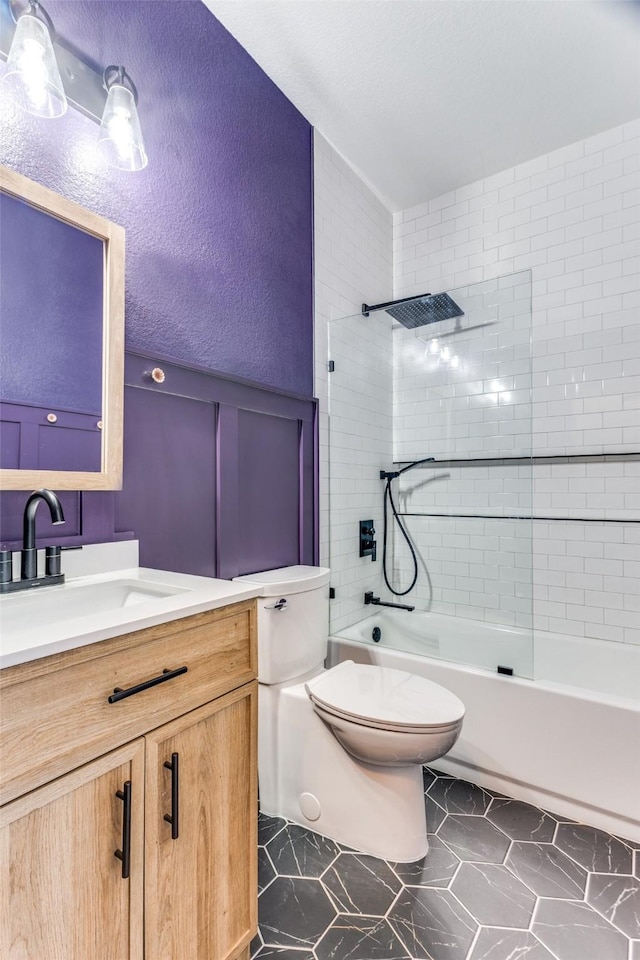 bathroom with toilet, tub / shower combination, and vanity