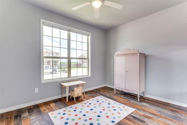 miscellaneous room featuring wood finished floors, baseboards, and a ceiling fan