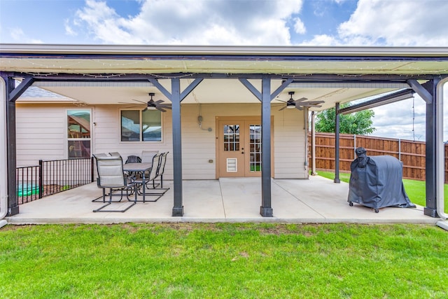 back of property with a ceiling fan, a patio area, and french doors