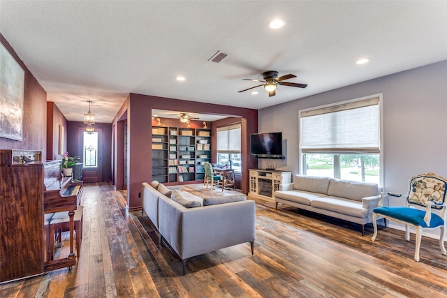 living room featuring hardwood / wood-style flooring, a ceiling fan, healthy amount of natural light, and recessed lighting