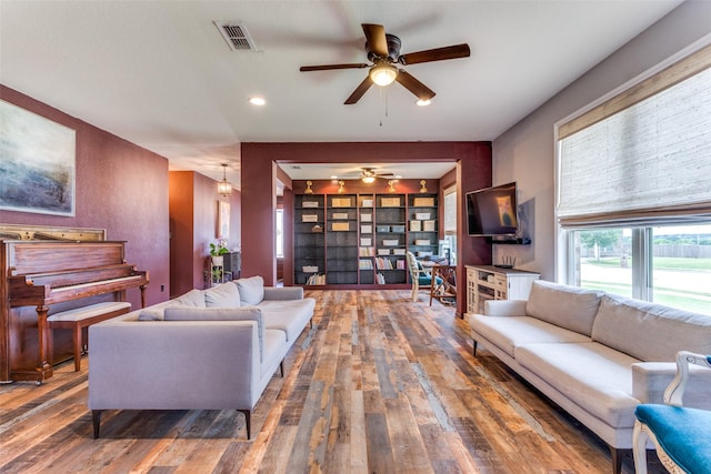 living area featuring ceiling fan and hardwood / wood-style flooring