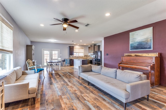 living area with a ceiling fan, hardwood / wood-style flooring, recessed lighting, french doors, and baseboards