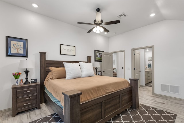 bedroom with light wood finished floors, a ceiling fan, visible vents, and connected bathroom