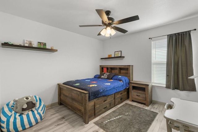 bedroom featuring a ceiling fan and wood finished floors