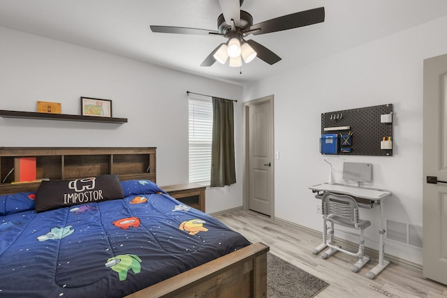 bedroom with visible vents, ceiling fan, wood finished floors, and baseboards