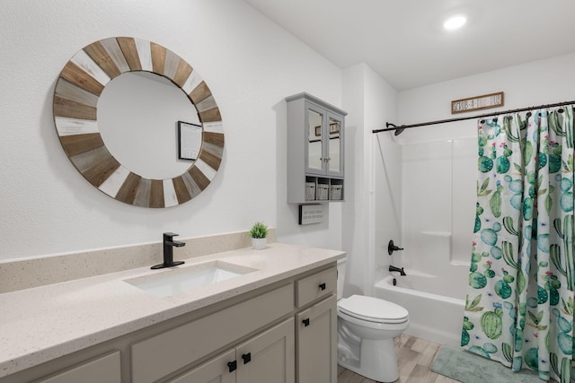 full bathroom featuring shower / bath combo, wood finished floors, toilet, and vanity