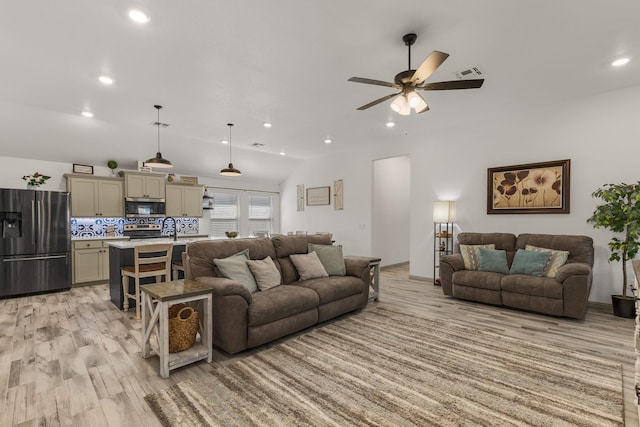 living room featuring recessed lighting, light wood-style floors, visible vents, a ceiling fan, and lofted ceiling