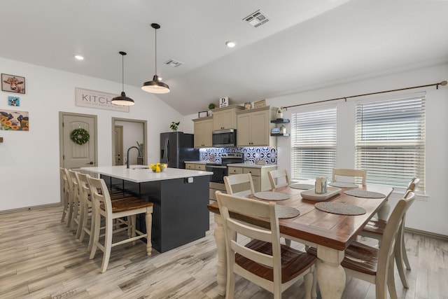 dining room with recessed lighting, visible vents, vaulted ceiling, and light wood-type flooring