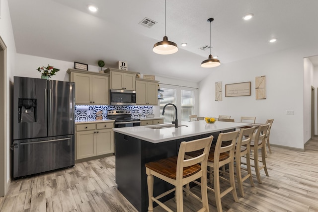 kitchen with visible vents, stainless steel appliances, light countertops, and a sink