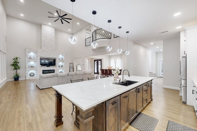 7401 Retta Mansfield Rd, Mansfield, TX 76063 - kitchen featuring appliances with stainless steel finishes, custom exhaust hood, light wood-style flooring, and tasteful backsplash