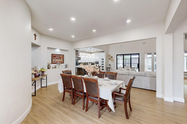 dining area with light wood-style floors, recessed lighting, baseboards, and visible vents