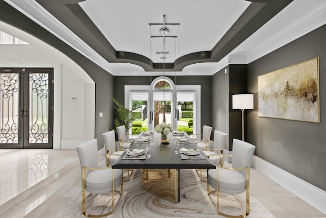 dining space with arched walkways, tile patterned floors, french doors, a tray ceiling, and visible vents