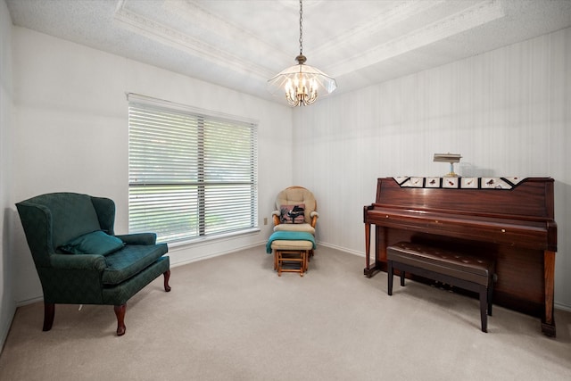 sitting room featuring baseboards, an inviting chandelier, carpet, and a tray ceiling