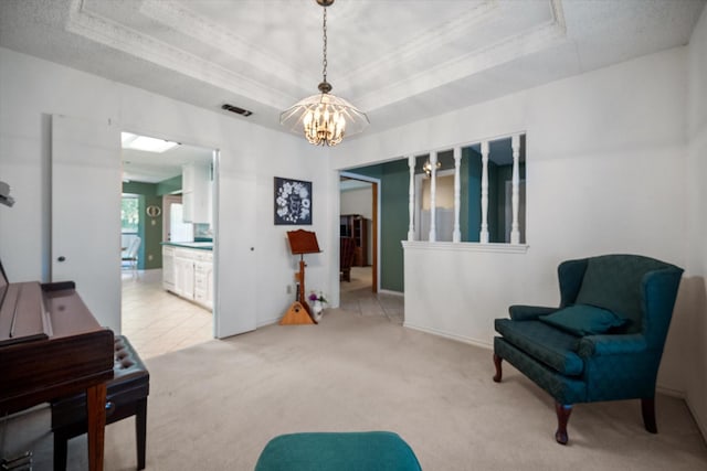 sitting room featuring light colored carpet, visible vents, a raised ceiling, a chandelier, and ornamental molding