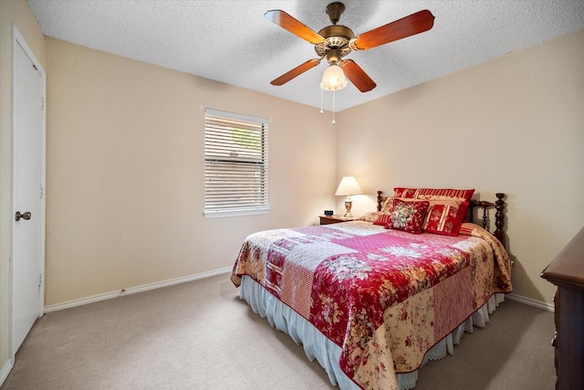 bedroom featuring carpet, a ceiling fan, a textured ceiling, and baseboards