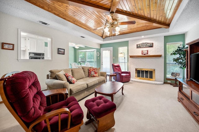 living area featuring a ceiling fan, visible vents, and wooden ceiling