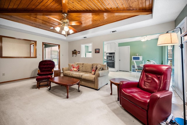 living room with wooden ceiling, ceiling fan, and a raised ceiling