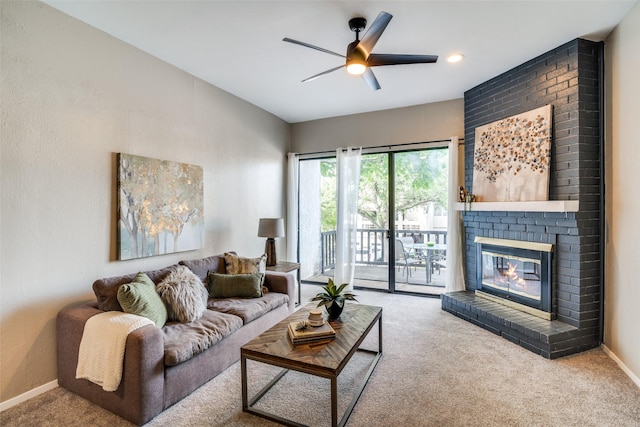 living room with a ceiling fan, carpet flooring, baseboards, and a brick fireplace