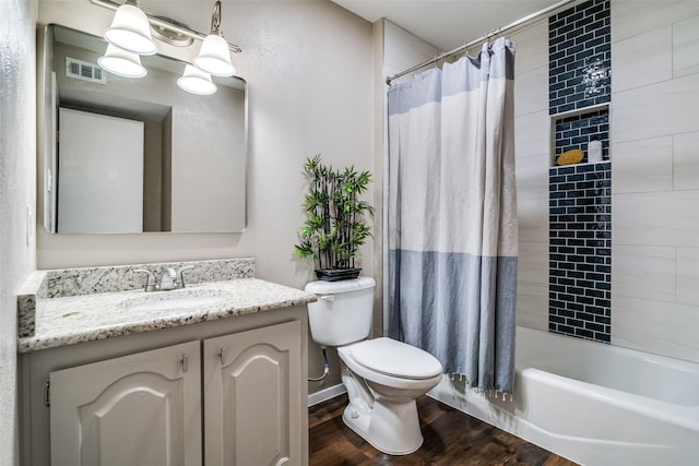 full bathroom featuring shower / tub combo with curtain, vanity, toilet, wood finished floors, and visible vents