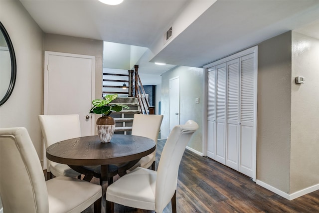 dining room featuring stairway, baseboards, and dark wood-style flooring