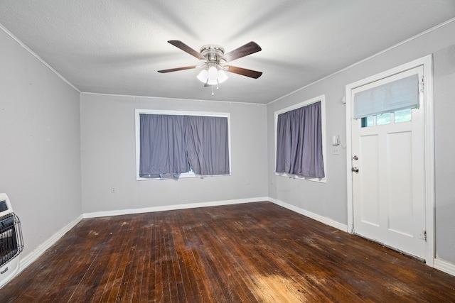 entrance foyer featuring heating unit, ceiling fan, hardwood / wood-style flooring, and baseboards