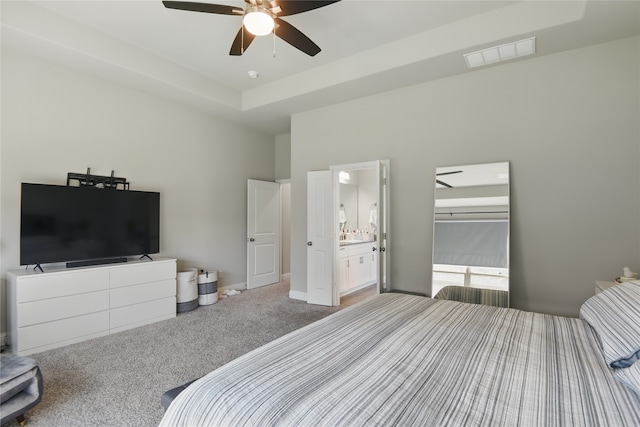 1164 Red Hawk Ln, Forney, TX 75126 - bedroom with visible vents, a tray ceiling, carpet floors, a ceiling fan, and ensuite bath
