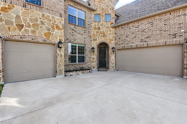 1164 Red Hawk Ln, Forney, TX 75126 - view of front of property featuring concrete driveway, stone siding, a shingled roof, brick siding, and a garage