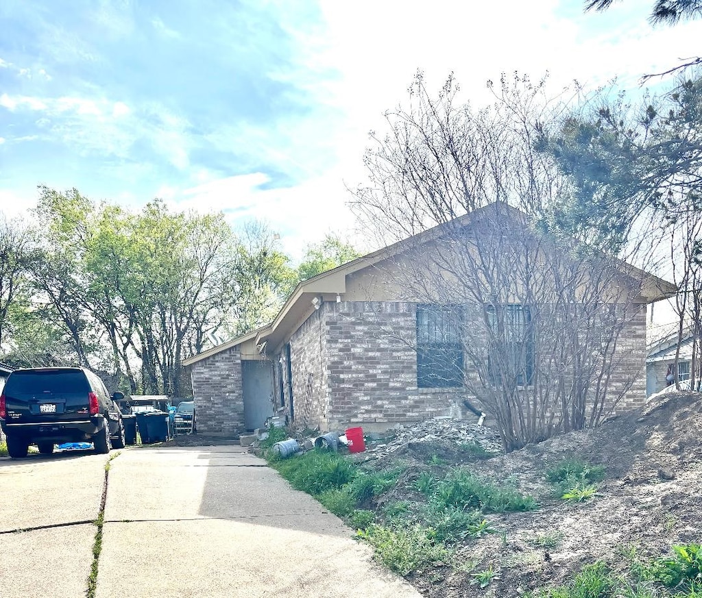 view of side of home with driveway