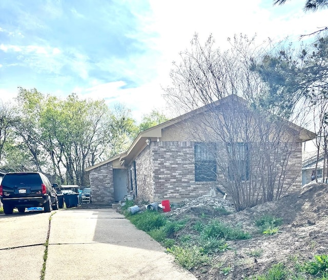 view of side of home with driveway