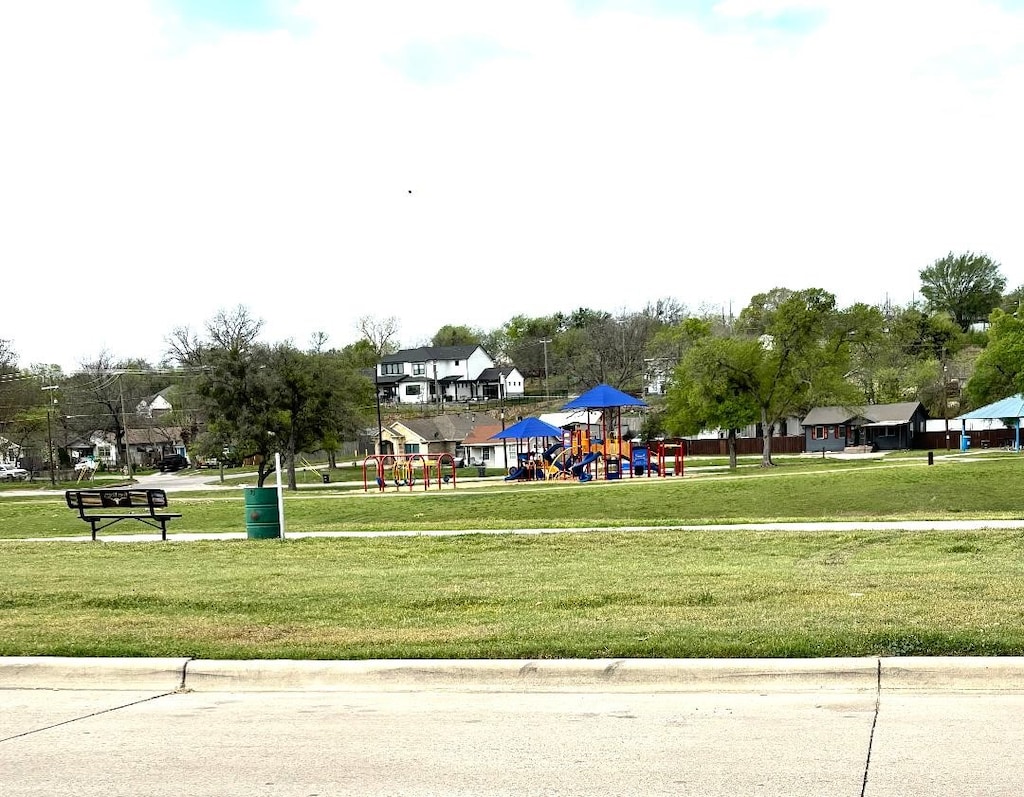surrounding community featuring a lawn and playground community